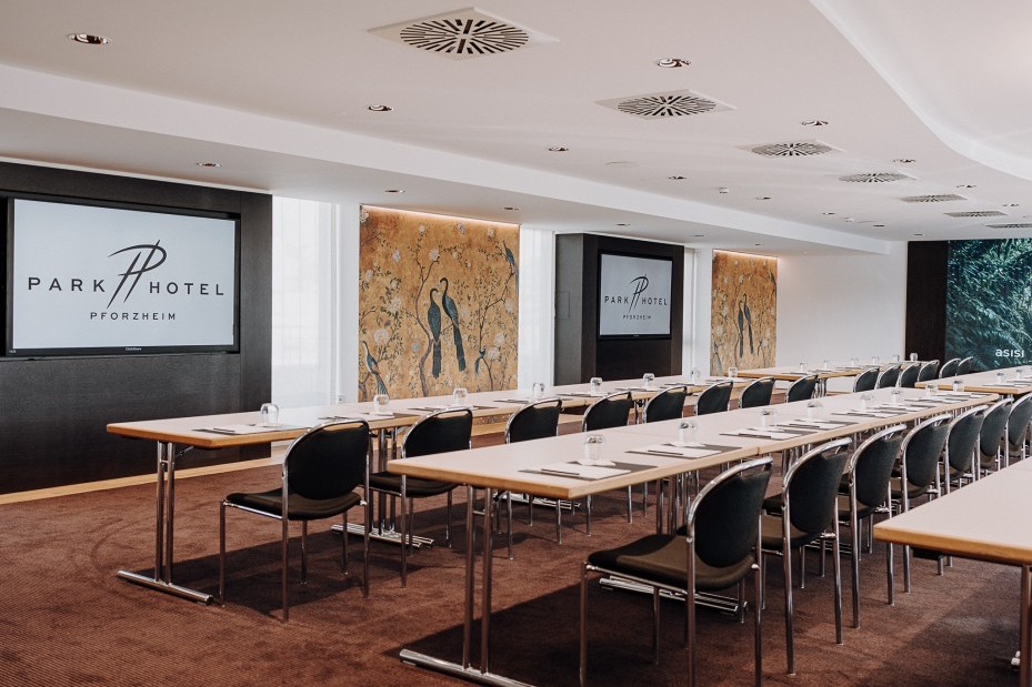 Parlamentarische Bestuhlung in Richtung zwei Bildschirme